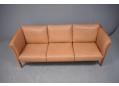All leather upholstered box sofa with cherry ends made by Skalma