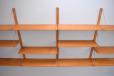 Neat vintage modular shelving system in teak with brass supports for sale