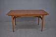 midcentury teak dining table with single leaf stored inside