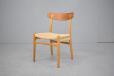 Vintage oak and teak dining chair with woven papercord seat designed by Hans Wegner