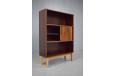 Tall rosewood cabinet with light oak legs and sliding door storage for sale