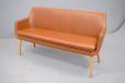 Modern sofa bench in brown leather upholstery on round tapering oak legs for sale