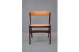 Vintage dining chair in teak with orange vinyl upholstery designed by Henry Kjaernulf 