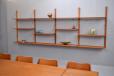 Vintage teak shelving system with brass supports produced in the 1960s