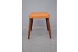 Vintage danish footstool with teak legs and vinyl upholstery