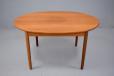 Vintage 1960s design teak dining table with oval top, extending with one extra leaf