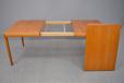 Vintage teak dining table extending with one self stored leaf designed by Henry W Klein | Model 473