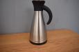 Stylish stainless steel thermos jug with black plastic lid 