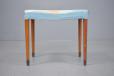 Midcentury design footstool with blue upholstery and blue upholstery