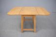 Midcentury design light oak coffee table with drop leaves produced by Danish Cabinetmaker