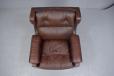 midcentury wing back armchair with chrome castors in original brown leather uphlstery